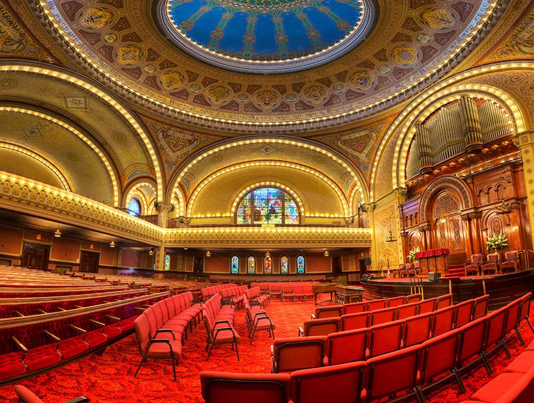 The carpet, seating area, and painted dome inside Congregation Sherith Israel's sanctuary building